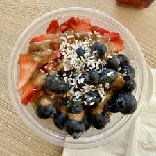 Top view of an acai bowl with spoon and napkin.