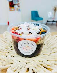 Acai bowl on a woven tray with a bright background.